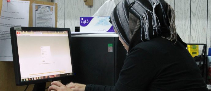 Arab woman sitting at computer
