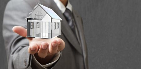 person holding a house