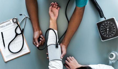 nurse taking person's blood pressure