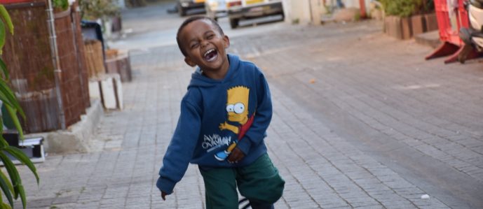 Ethiopian boy running in street