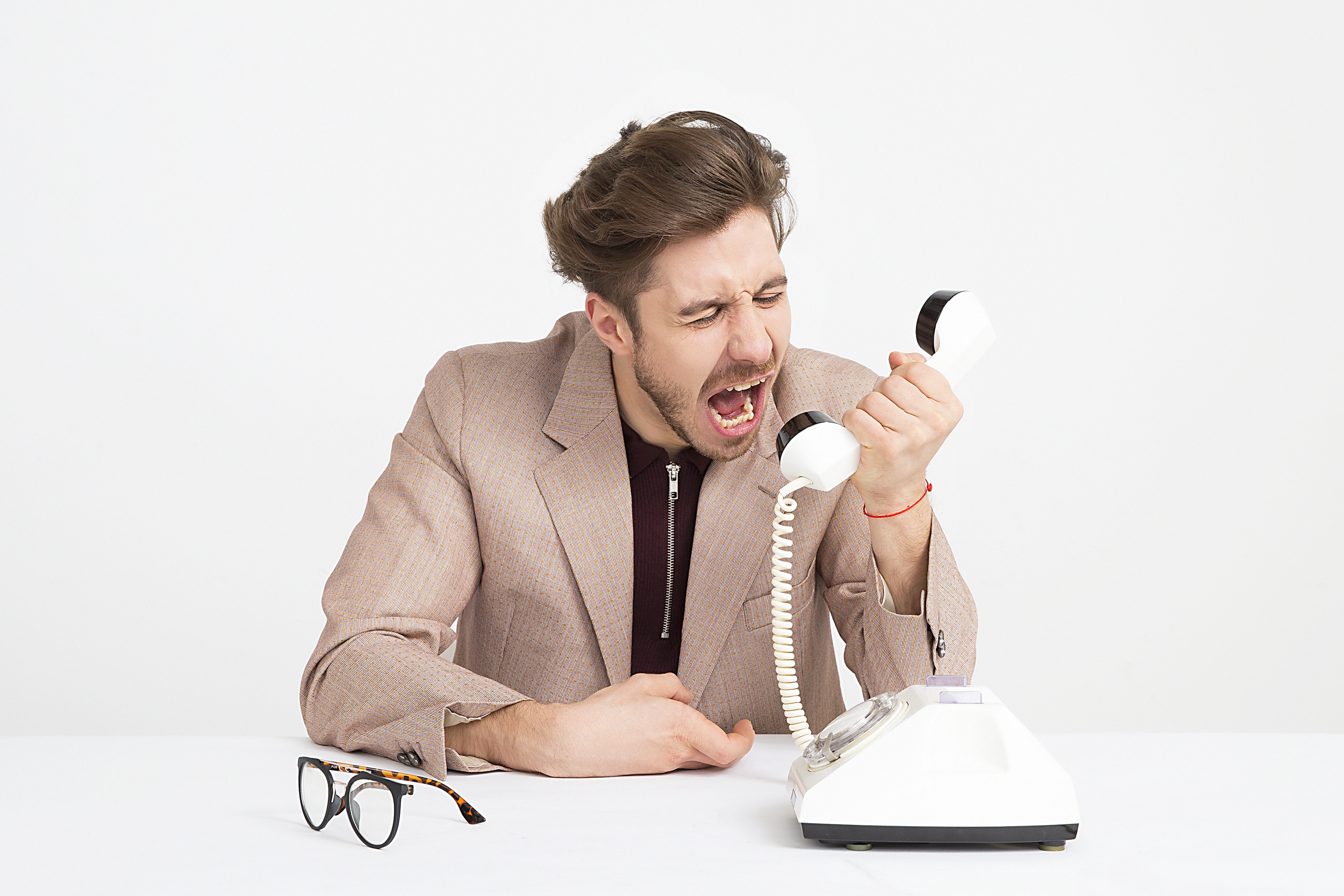 man shouting at the phone